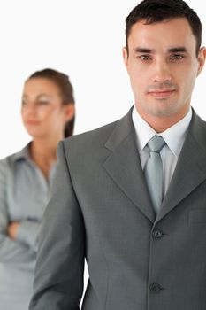 Close up of businessman with colleague behind him against a white background