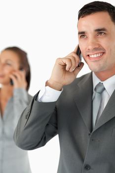 Close up of business team on the phone against a white background