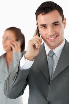 Close up of colleagues on the phone against a white background