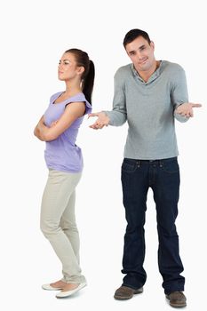 Young male has no clue why his girlfriend is upset against a white background