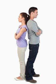 Young couple standing back-to-back against a white background