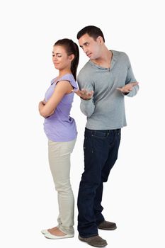 Young male asking his girlfriend for forgiveness against a white background