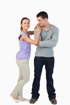 Young female leaning on her boyfriend's shoulder against a white background