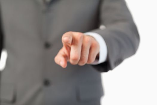 Close up of finger pressing a invisible touchscreen against a white background