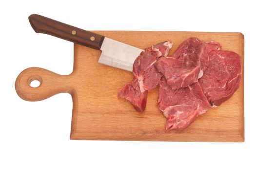 Slices of the meat on the board with knife on the kitchen