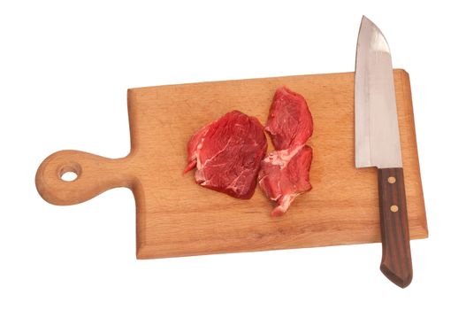 Slices of the meat on the board with knife on the kitchen