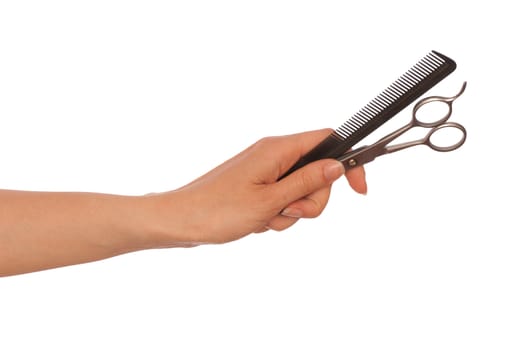 hairdresser holds scissors and hairbrush for haircut