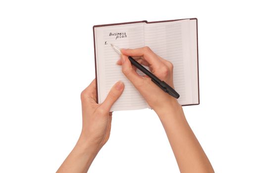 business woman writes notes for business plan