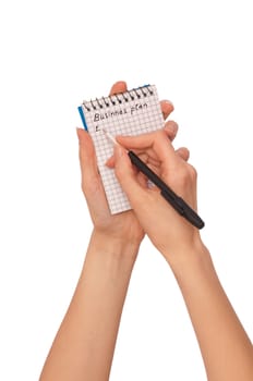business woman writes notes for business plan