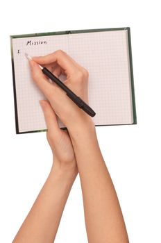 business woman writes mission for business plan