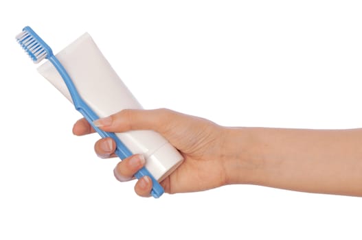 Tooth-paste and brush at in the girl's hand