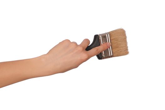 The woman draws the brush on the wall