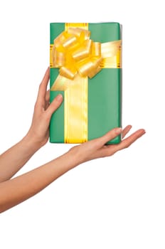 woman giving a green box with yellow bow as a gift