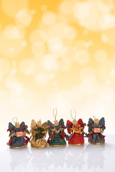 Decorative christmas angels with golden bokeh effect. Copy space