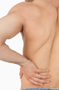 Young male having back pain against a white background