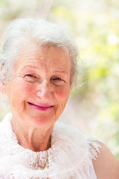 Grandmother looking at you confidently with her white hair and complimenting nice clothing.