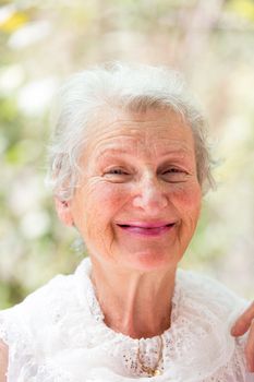 Grandmother looking at you happily  with her white hair and complimenting nice clothing.