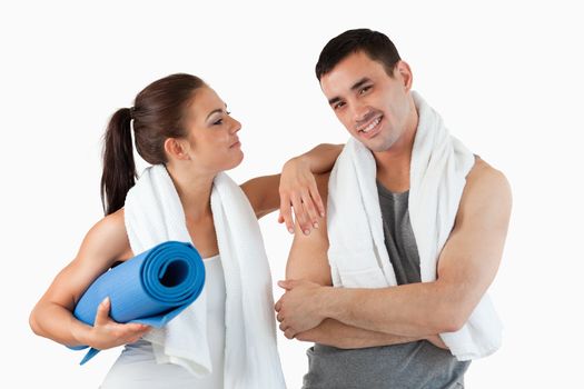 Young couple going to practice yoga against a white background