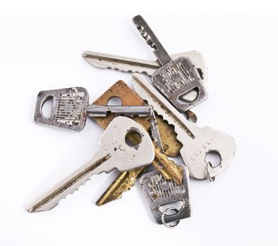 Old rusty keys isolated on white background. Top view