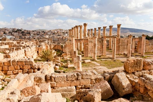 ruined ancient jerash in jordan with the modern city in the background