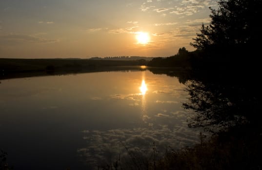 Beautiful sunrise over river with trees. Morning landscape