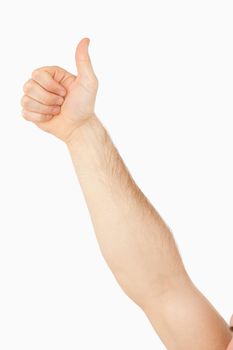 Side view of male arm giving thumb up against a white background