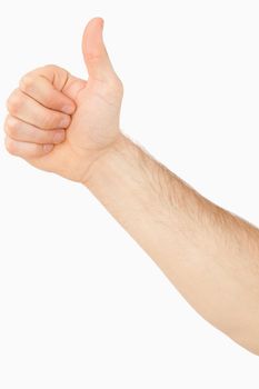 Side view of male thumb up against a white background