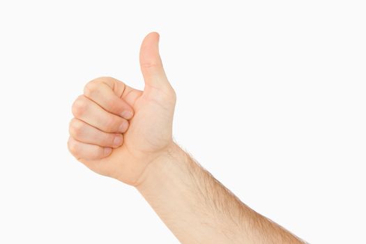 Side view of thumb up against a white background