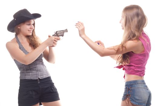 Portrait of two young girls with a gun shooting studio