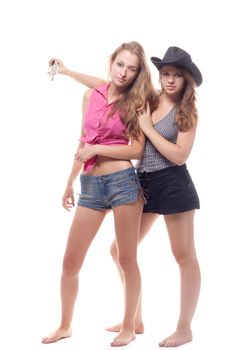 Portrait of two young girls with a gun shooting studio