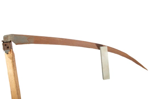 rusty old scythe and the whetstone on a white background