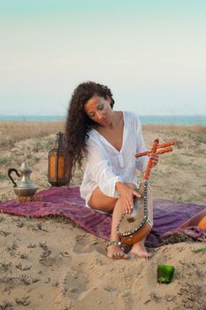 Woman surrounded by  African elements on a dune