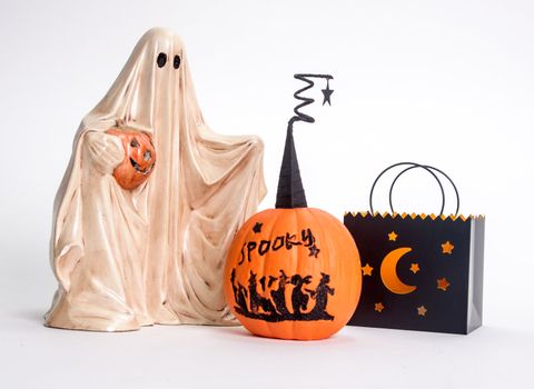 Ghost, pumpkins, and candle isolated on white background