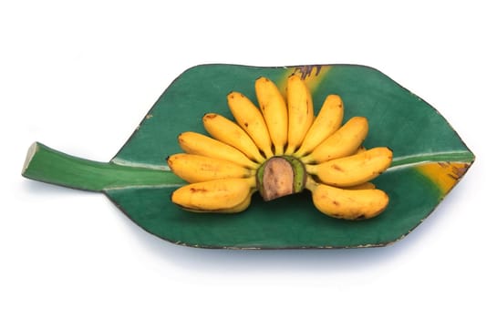 Bunch of bananas on a banana leaf, wooden tray isolated over white background 
