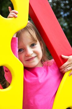 Cute smiling little girl  on playground posing. Portrait