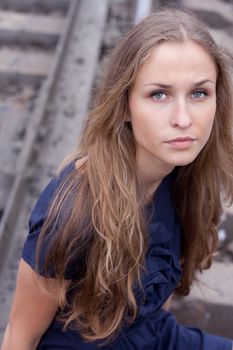 Woman sitting on rails outdoors shooting