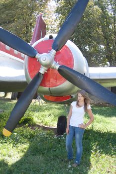 beautiful girl on the background plane survey at the Museum