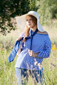 beautiful girl in the shirt on the grass outdoors shooting