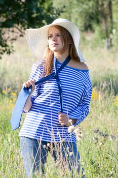 beautiful girl in the shirt on the grass outdoors shooting