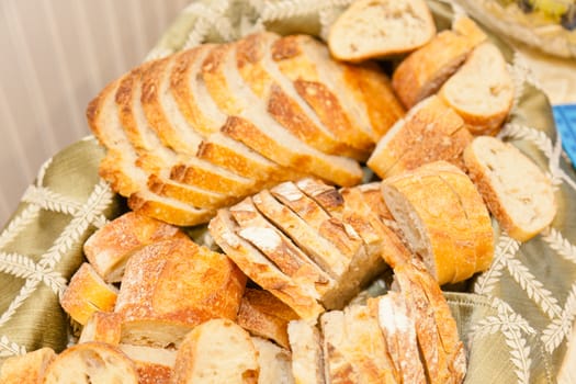 Delicious sourdough bread in a backet on party table.