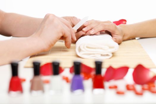 Young woman is getting manicure in a beauty salon