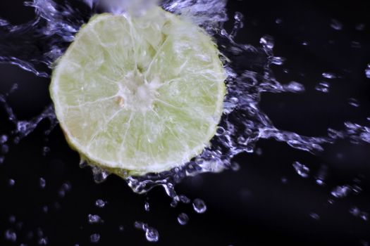 water splash with lemon in a black background