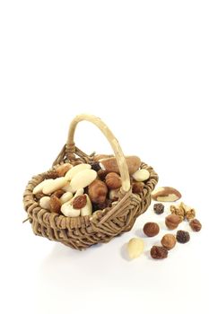 Mixed nuts and raisins as a snack on a light background