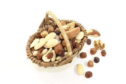 fresh crunchy mixed nuts and raisins as a snack on a light background