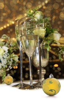 Glasses  champagne against a gold sparkle christmas background