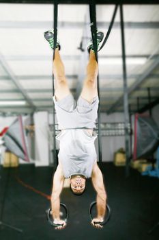 The sportsman the guy, carries out difficult exercise, sports gymnastics