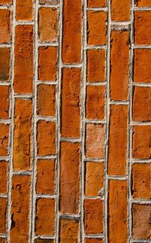 Wall closeup built of red brick background. Architectural details.