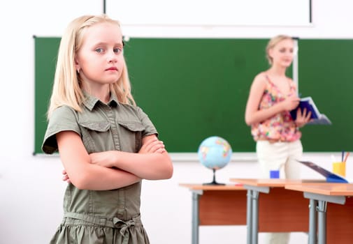 portrait of schoolgirl crossed her arms and looked at the camera