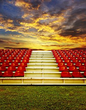 Red bleachers with sunset sky background