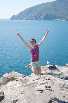 girl jumping on the background of the sea outdoors shooting